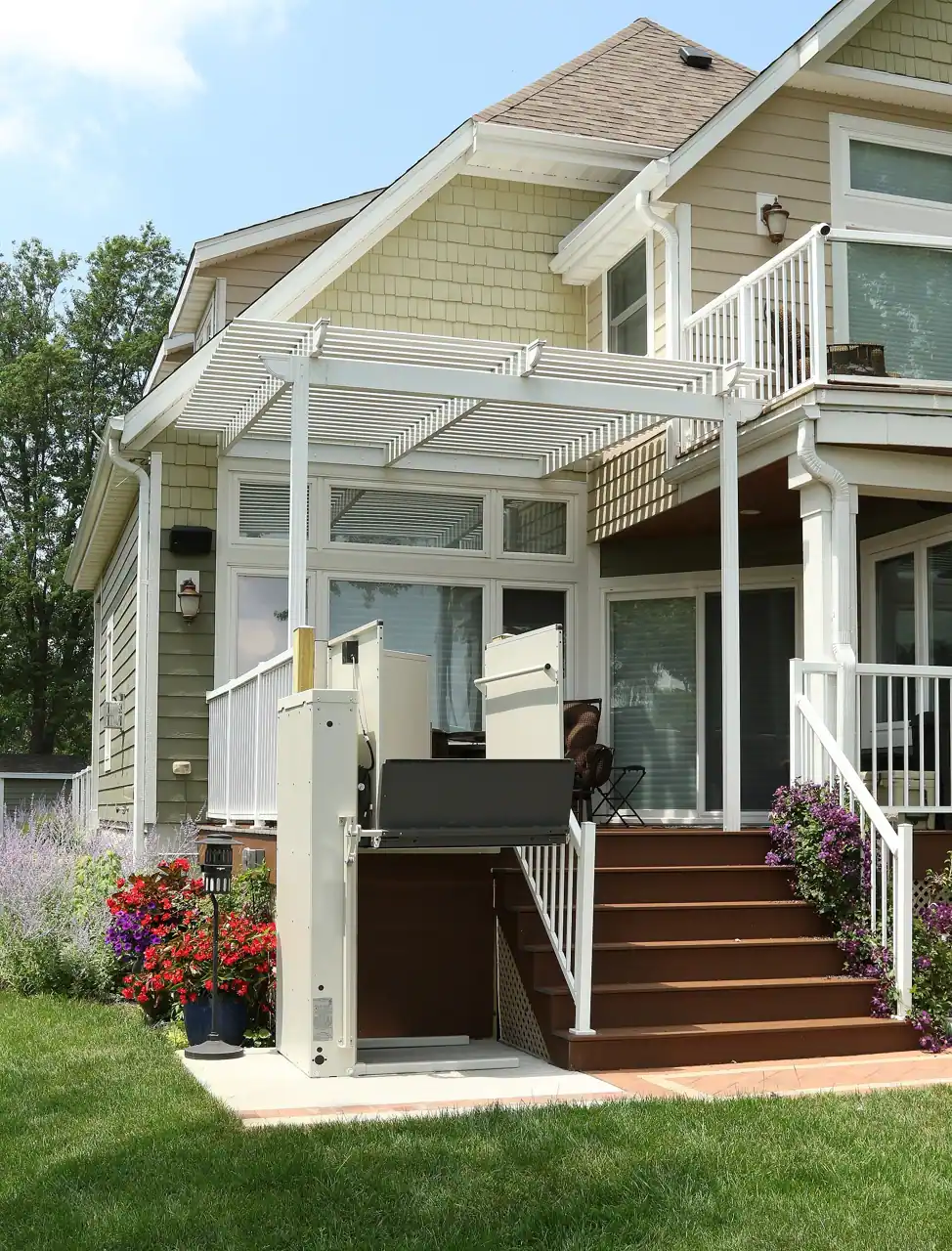 Vertical platform lift beside the steps of a home