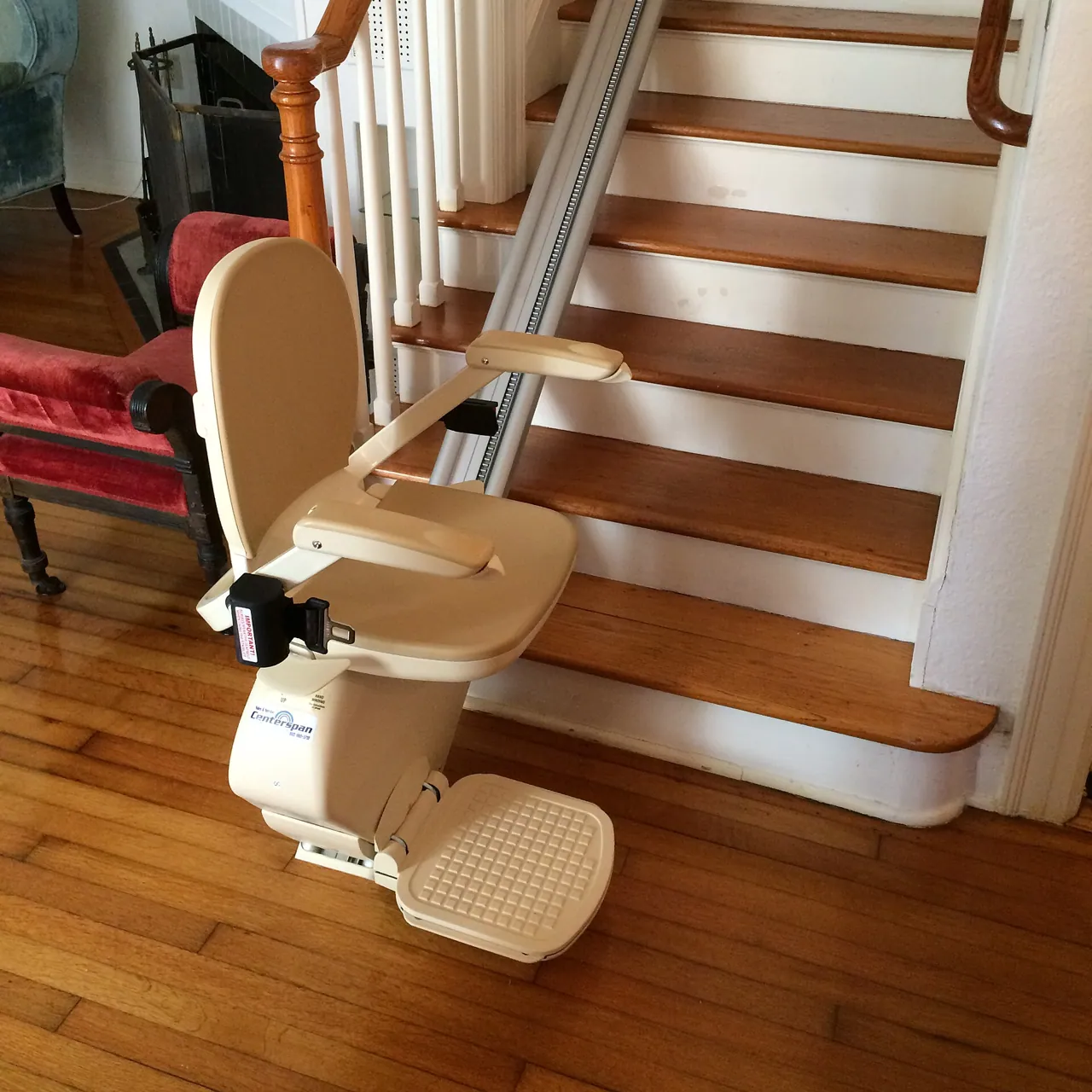 Stair lift with folding seat installed on a home staircase