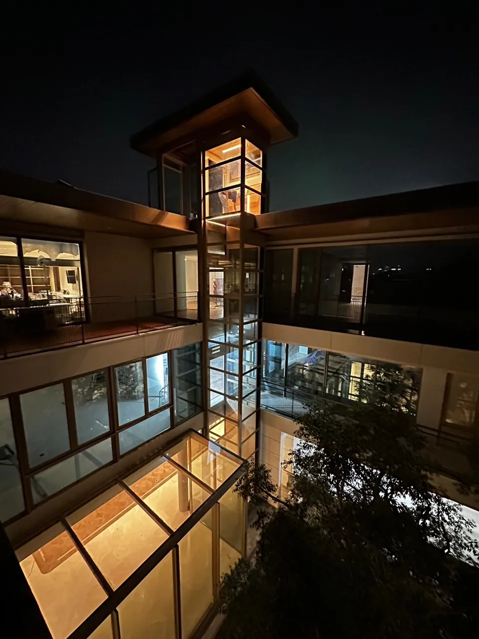 Glass outdoor elevator tower on the side of a house