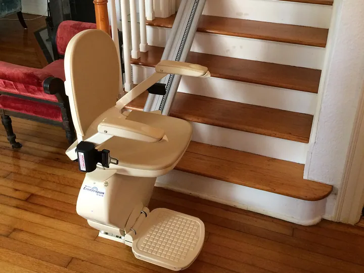 Stair lift with folding seat installed on a home staircase