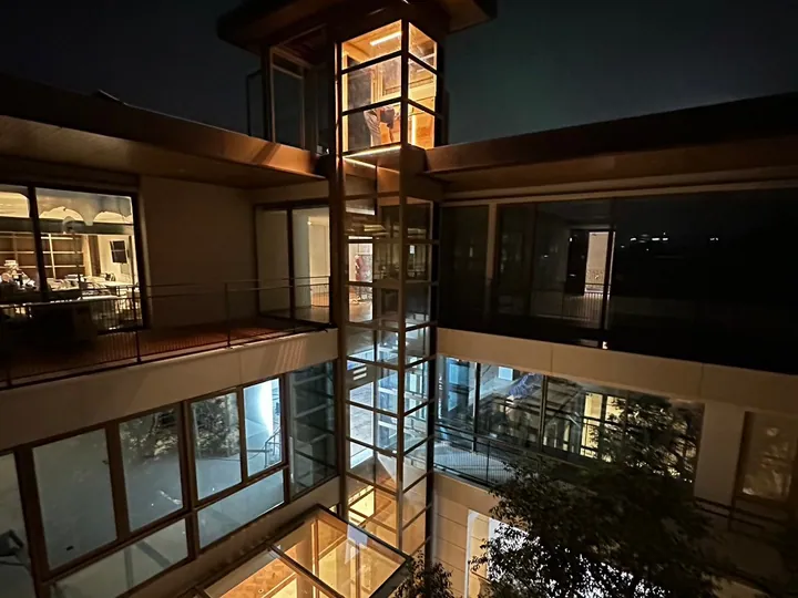 Glass outdoor elevator tower on the side of a house