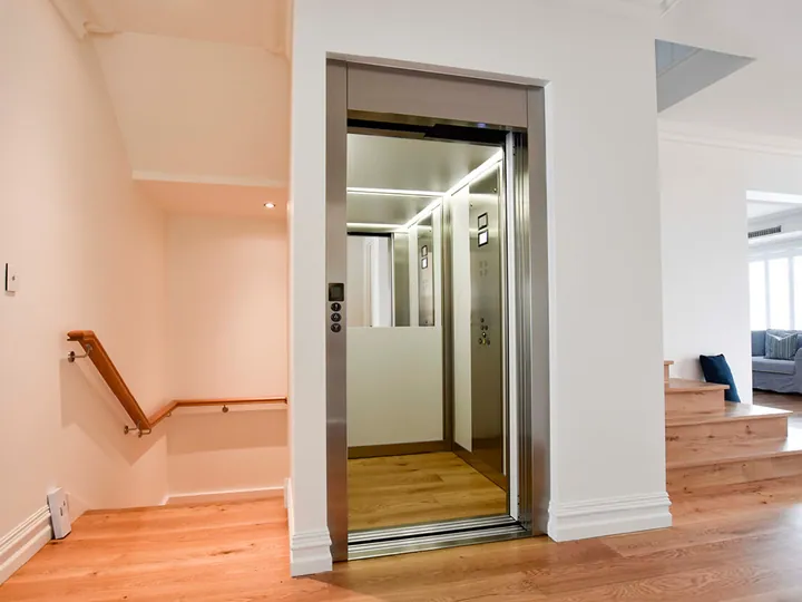Residential elevator with glass doors in a modern two-storey home